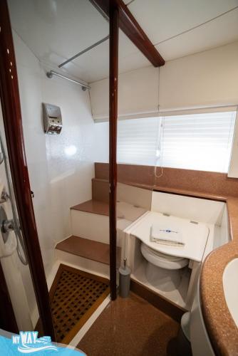a small bathroom with a toilet and a sink at Barco no Coração da Cidade - Iate de 5 estrelas in Viana do Castelo