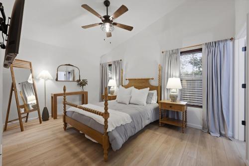 a bedroom with a bed and a ceiling fan at Cozy Coastal Cottage Minutes to Beach and Downtown in St. Augustine