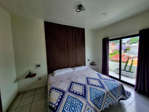 a bedroom with a bed and a large window at Vista Sumidero in Tuxtla Gutiérrez