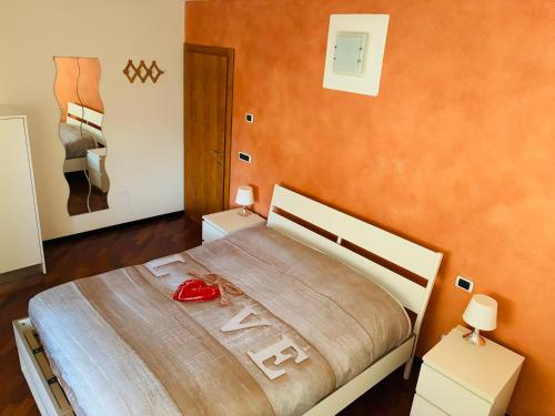 a bedroom with a large bed with two night stands at Casa Vacanza l' antico molino in Grosotto