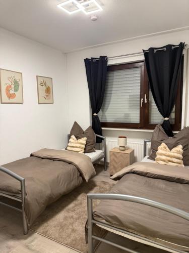 a bedroom with two beds and a window at Gaststätte Seehaus Maroth in Maroth