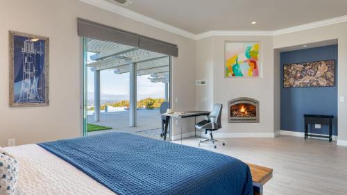 a bedroom with a bed and a desk and a fireplace at Summit Ranch by AvantStay in Temecula