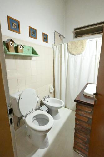 a bathroom with a toilet and a sink at Casa Amaranta in La Cumbre