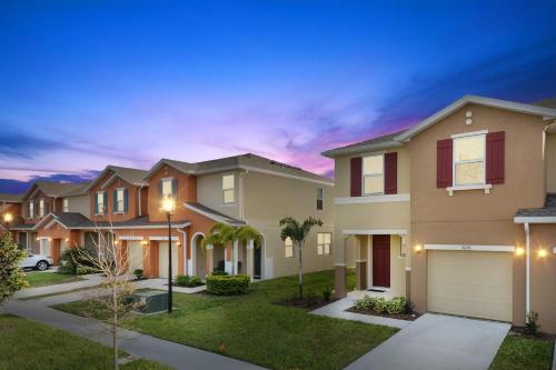 a house with a garage at night at Four Bedrooms Resort TownHome 5128 in Kissimmee
