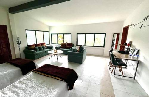a large living room with a bed and a couch at La Enamorada Cabañas & Resort in Zacatlán
