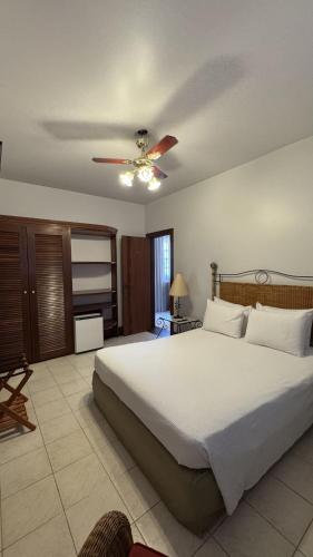 a bedroom with a bed and a ceiling fan at Hotel Fazenda Lagoa Grande in Sete Lagoas