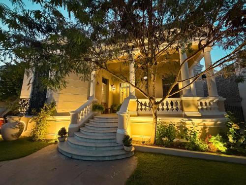 a house with a staircase in front of it at Casa Ku'x in Mérida