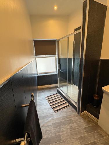 a bathroom with a shower and a towel on a rack at Elegance apartments in West Cornforth