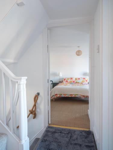 a bedroom with a door leading to a bed at Harbour View in Aberaeron
