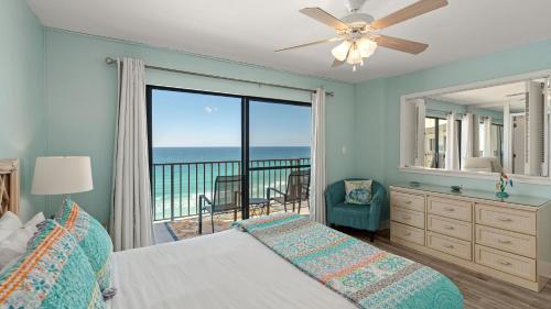 a bedroom with a bed and a view of the ocean at Gull Watch by AvantStay in Panama City Beach