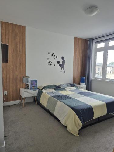 a bedroom with a large bed and a window at The Creek Home in Kemptville