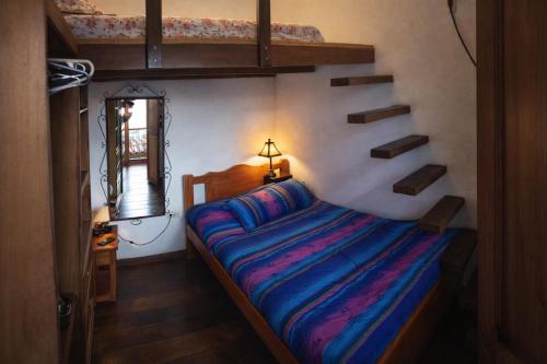 a bedroom with a bed with a blue comforter at Casona Rosa Lorenza in Corrales