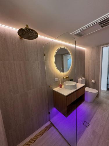 a bathroom with a sink and a mirror at Luxury self-contained guest suite in Gold Coast