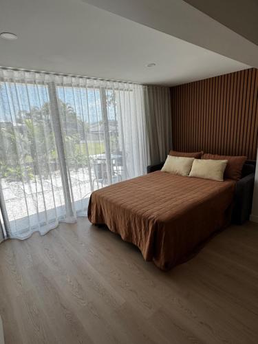a bedroom with a large bed and a large window at Luxury self-contained guest suite in Gold Coast