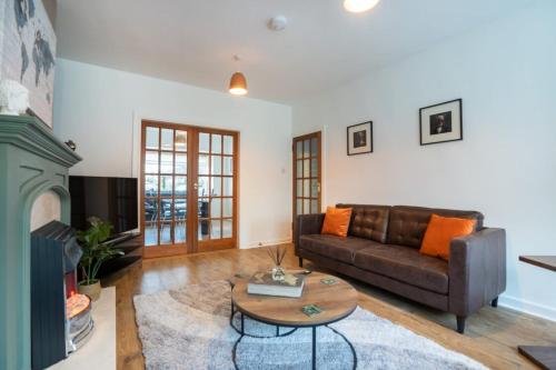 a living room with a couch and a coffee table at 10-min to City Centre 2 Bedrooms Sleeps4 with Free Parking Garden & WiFi in Aberdeen