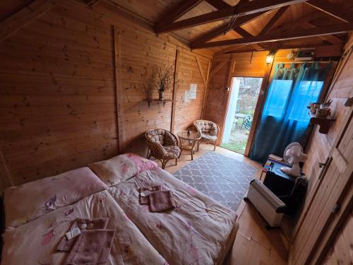 a bedroom with a bed in a wooden cabin at Prague Retro Challenge and Garden in Prague