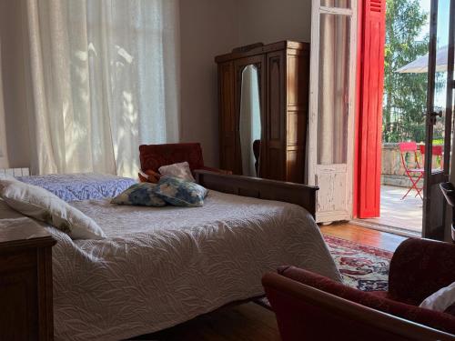 a bedroom with a bed and a sliding glass door at Lingaillat in Soorts-Hossegor