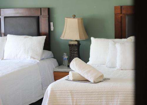 a bedroom with two beds and a lamp on a table at Casa Mestiza in Guadalajara