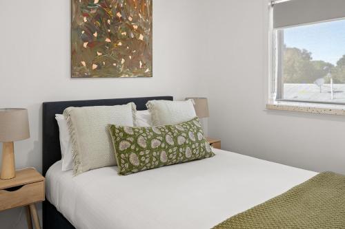 a bedroom with a white bed and a window at Loxton Courthouse Apartments in Loxton