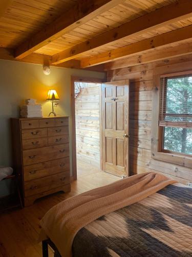a bedroom with a bed and a dresser and a window at Turkey Ridge Retreat in Bryson City