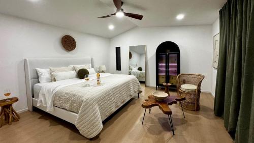 a bedroom with a bed and a ceiling fan at Custom Tiny House in Valle in Francisco Zarco