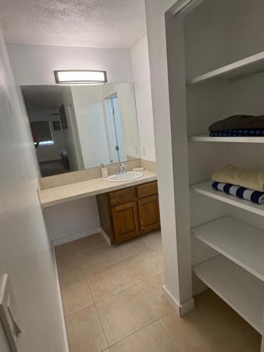 a bathroom with a sink and a mirror at Private Oasis Condo with River views across from Laughlin in Bullhead City