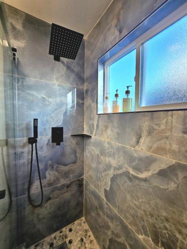 a bathroom with a shower with a window at Stay in the Heart of Hillcrest! in San Diego