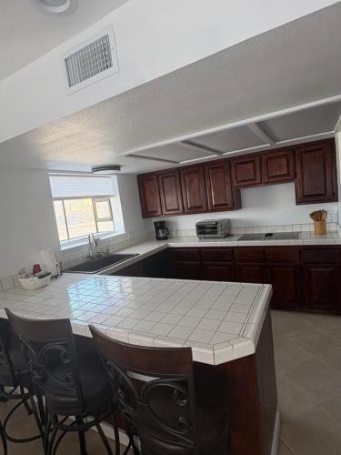 a kitchen with a table and some chairs in it at Private Oasis Condo with River views across from Laughlin in Bullhead City