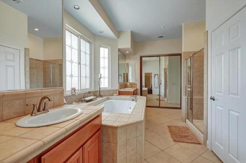 a large bathroom with a sink and a tub at Beautiful Villa with Amazing 360 Mountain Views, Golfcourses close to Monserate Winery and I-15 in Fallbrook