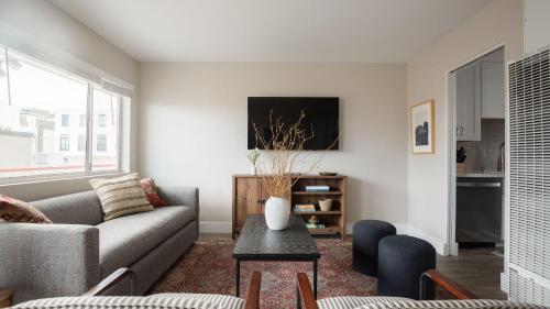 a living room with a couch and a table at Seashore VII by AvantStay Modern La Jolla Flat 5mins from the Beach in San Diego