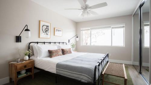 a bedroom with a bed and a ceiling fan at Seashore VII by AvantStay Modern La Jolla Flat 5mins from the Beach in San Diego