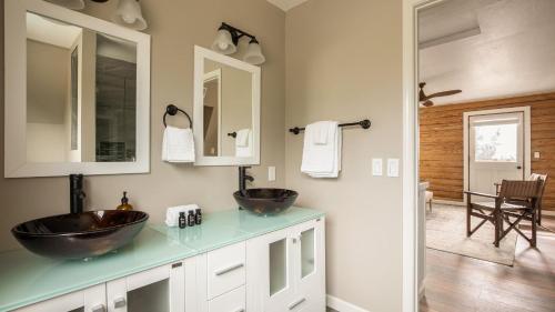 a bathroom with two sinks and a mirror at Chateau Syrah by AvantStay Picturesque Estate w Pool Hot Tub Table Tennis Pool Table New Pickleball Court Basketball hoop in Temecula