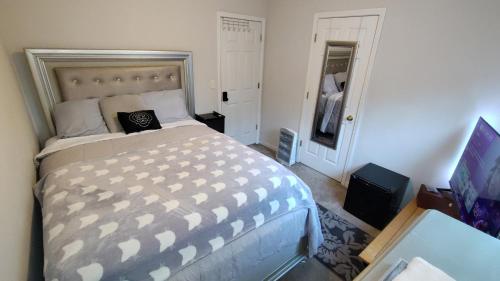 a bedroom with a large bed and a television at Kings Private Room Shared Bath C in Decatur