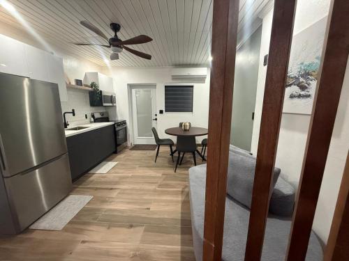 a kitchen with a table and a ceiling fan at Josie Cozy Corner in Grand Turk