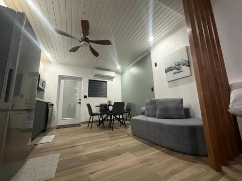 a living room with a couch and a ceiling fan at Josie Cozy Corner in Grand Turk