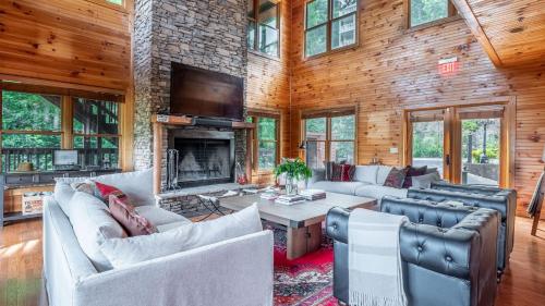 a living room with couches and a fireplace at Hickory Ridge by AvantStay Sleeps 20 Incredible Private Elevated Cabin in Gatlinburg
