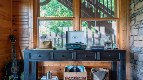 a table in a room with a window at Hickory Ridge by AvantStay Sleeps 20 Incredible Private Elevated Cabin in Gatlinburg
