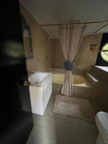 a bathroom with a tub and a sink and a bath tub at Afrodita Chalet in El Peñol