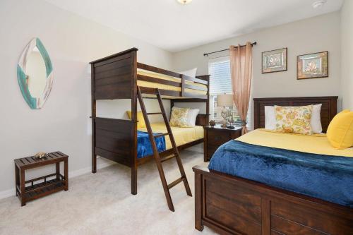 a bedroom with two bunk beds and a mirror at Four Bedrooms TownHome 5161 in Kissimmee