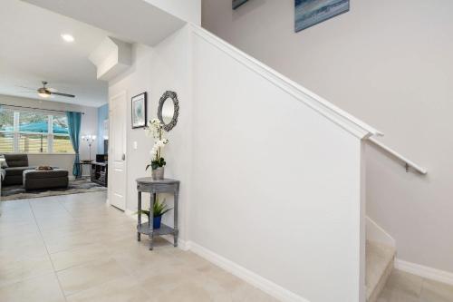 a living room with white walls and a staircase at Four Bedrooms TownHome 5161 in Kissimmee