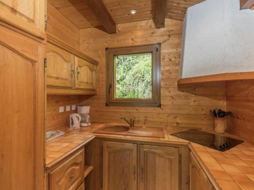 a kitchen with a sink and a window in a log cabin at Chalet in Vosges Forest with Valley View in La Bresse
