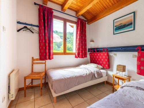 a bedroom with two beds and a window at Chalet in Vosges Forest with Valley View in La Bresse