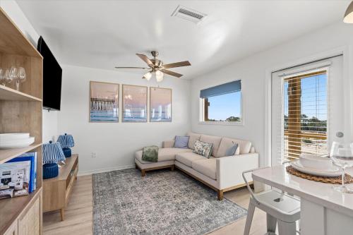 a living room with a couch and a table at High Point Hideaway on the Sand Dunes - Unit 2 in Dauphin Island