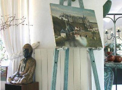 a statue sitting on a table next to a painting at L'Amandari - Chambres d'hôtes in Plan-de-la-Tour