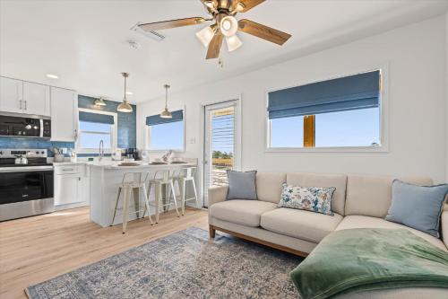 a living room with a couch and a kitchen at High Point Hideaway on the Sand Dunes - Unit 3 in Dauphin Island