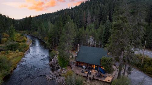 an aerial view of a house next to a river at Riversong Lodge by AvantStay Sauna Hot Tub On The Truckee River in Truckee