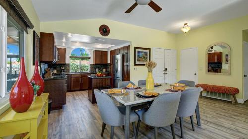 a kitchen and dining room with a table and chairs at Ranch Oasis w Private Pool HotTub Firepit Mountain Views Gobi by AvantStay in Palm Springs