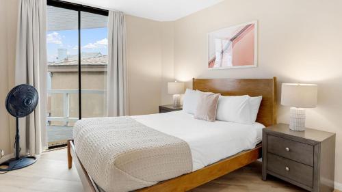 a bedroom with a bed and a large window at Beachfront Home w Ocean Views • Right on Mission Beach Belmont by AvantStay in San Diego