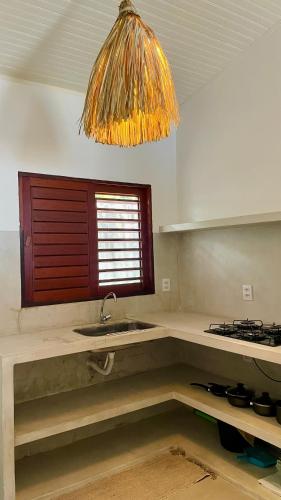 a kitchen with a sink and a window at Casas Gica in Pipa