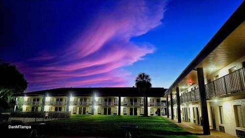 a large building with a cloudy sky at night at Days Inn by Wyndham Crystal River in Crystal River